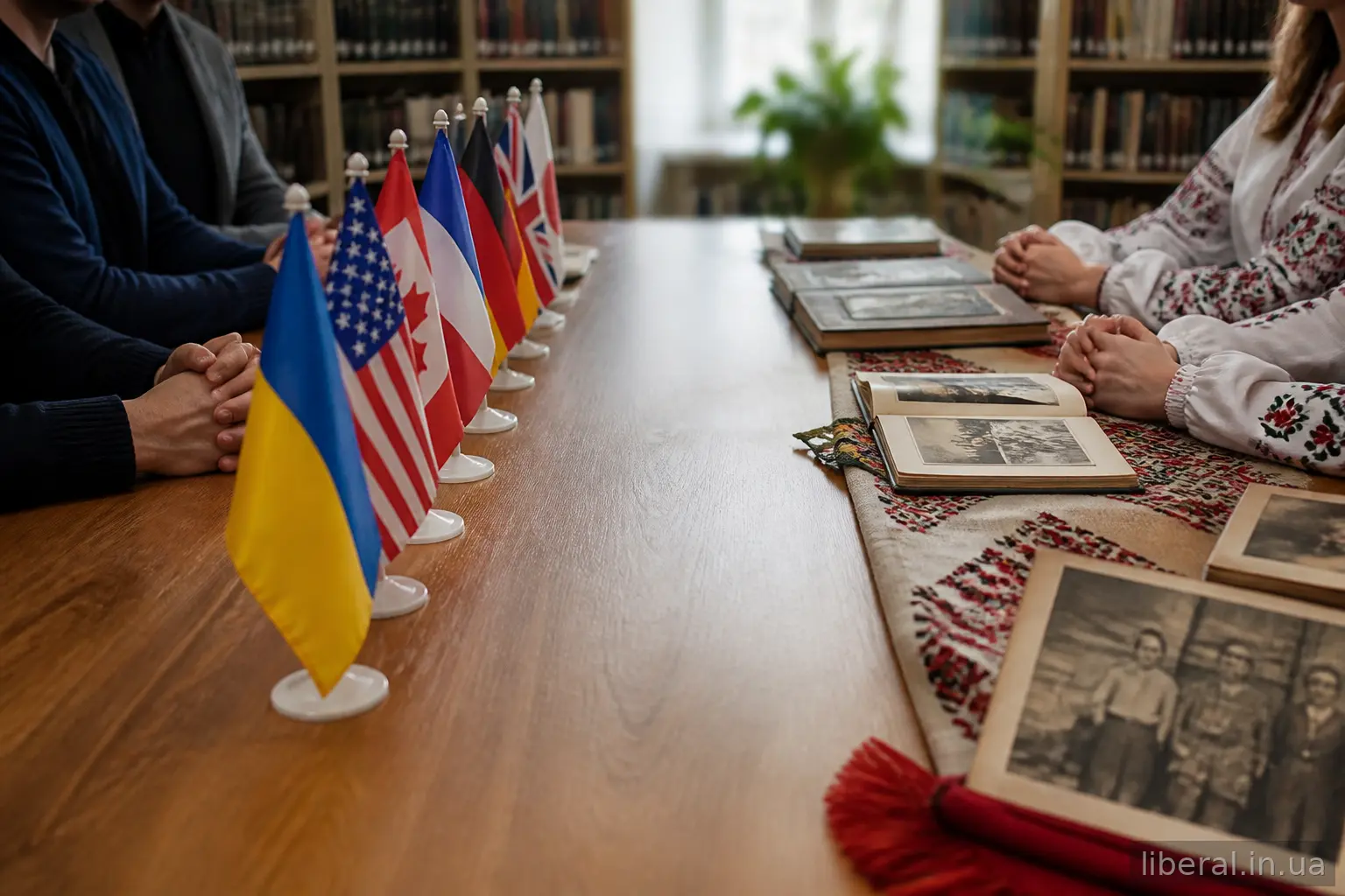 Дискусія за столом: прапори країн з одного боку та сімейні альбоми з традиційними тканинами з іншого